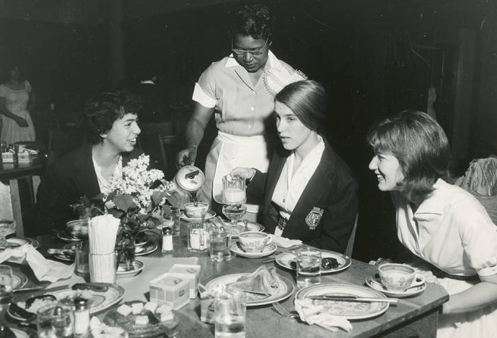 Image of Maid serving students at breakfast ca. 1950s or 1960s. | Bryn Mawr College Special Collections, Bryn Mawr, PA.